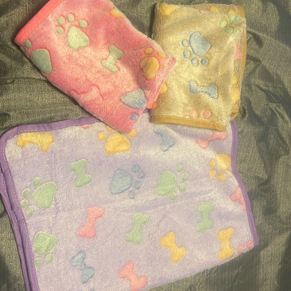 Dog blankets. Never used pack of three. Purple, tan and pink.